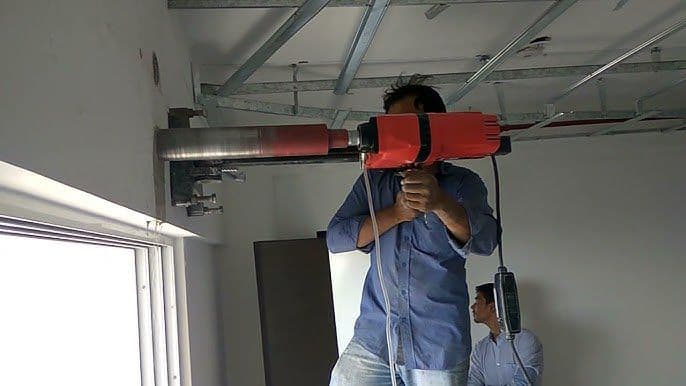 Diamond core drilling AC duct opening through concrete wall — Kerala
