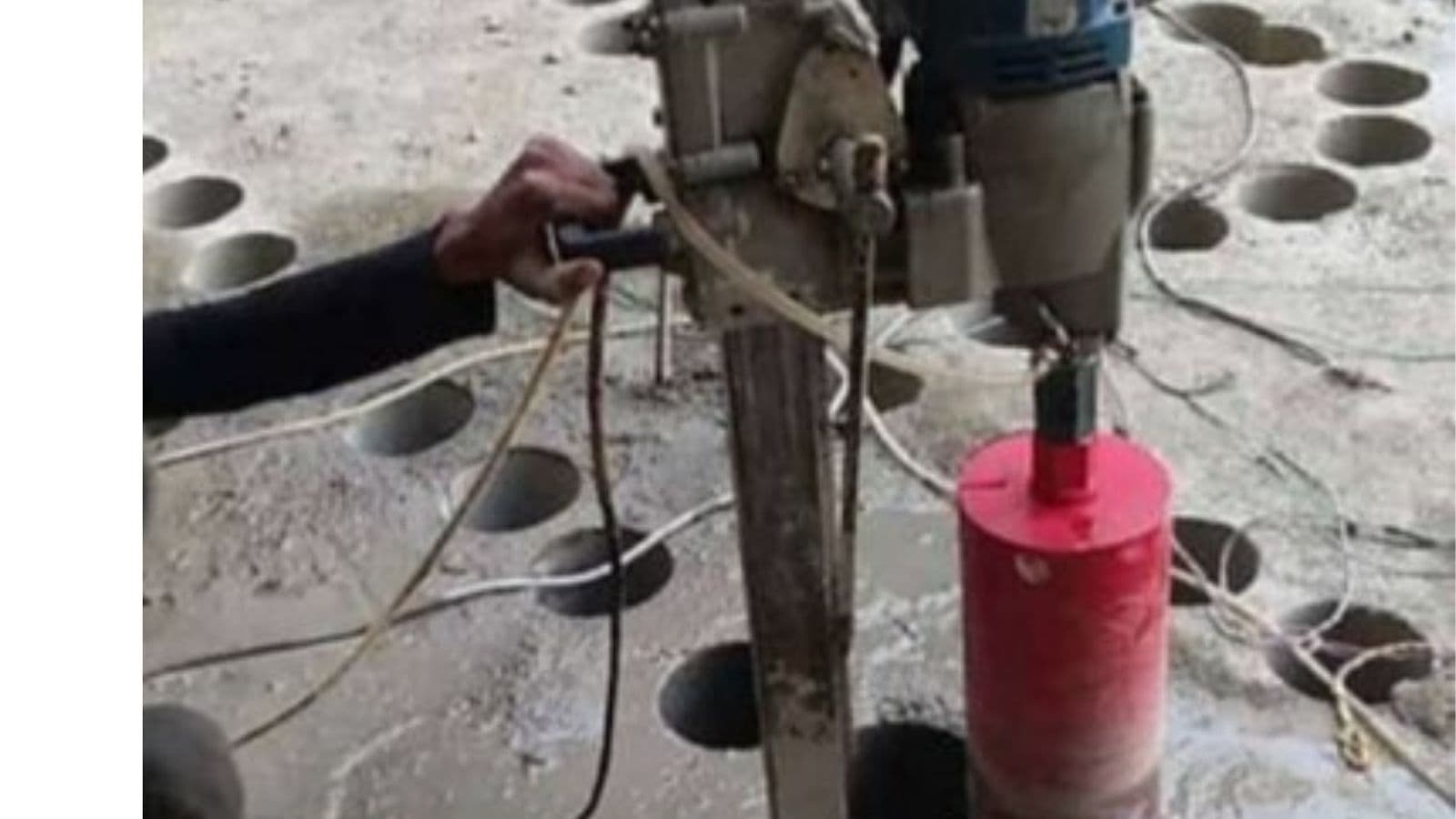 Worker cutting concrete slab core — slab core cutting Palakkad